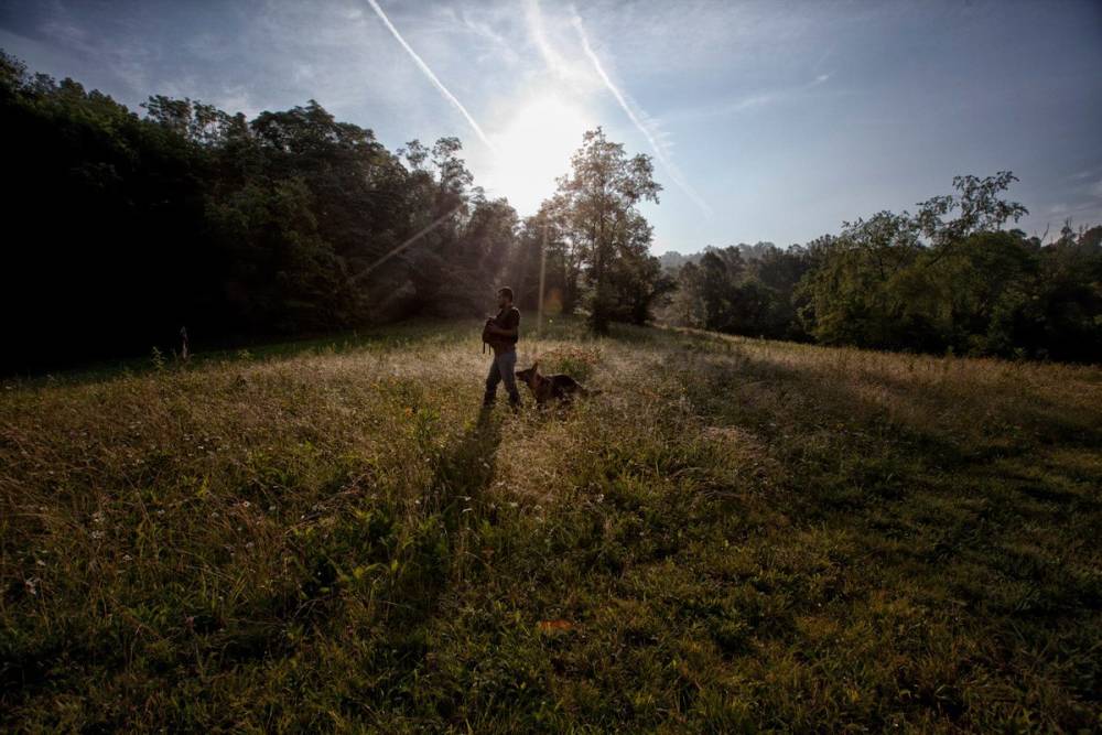 Sarah Menkedick's husband Jorge Santiago, with their daughter Elena and dog, at the setting of Sarah's book 'Homing Instincts', rural Ohio.