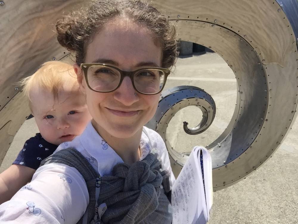 Andrea, baby wearing with her son August while on a research trip to the Ballard Locks in Seattle.